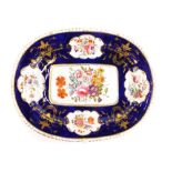 An early 19thC Derby porcelain meat dish, painted with flower sprays on a cobalt blue ground, (