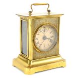 A German Junghans pressed brass carriage clock, with paper dial and loop handle, 19cm high.