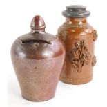 A 19thC stoneware baluster shaped money box (AF), 12cm high, and a stoneware tea caddy with pewter