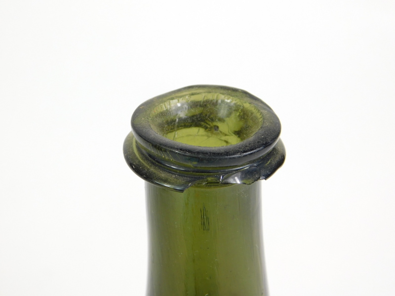 An 18thC green onion shaped green glass wine bottle, 21.5cm high. Reports are no longer given on - Image 2 of 3