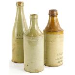 Two pale stoneware porter bottles, stamped J. Parker, Lincoln, S & P Lincoln and F.Clark Abbey
