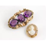 Two brooches, to include a cameo brooch with two layered oval surround, gold coloured but
