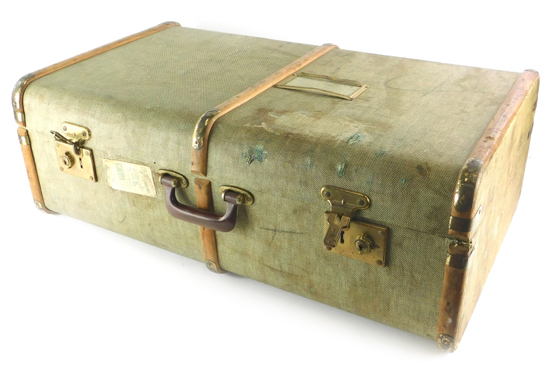 A green canvas and wooden bound suitcase or travel trunk, with brass effect metal mounts, British