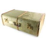 A green canvas and wooden bound suitcase or travel trunk, with brass effect metal mounts, British