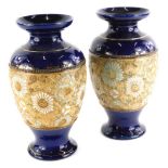 A pair of Doulton Slaters patent vases, each decorated with flowers in white and turquoise in cobalt