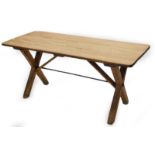 A 19thC pine tavern table, the rectangular planked top on X shaped supports with iron stretcher,