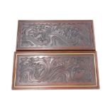 A pair of early 20thC carved mahogany panels, each decorated with birds, scrolls, etc., later