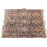 A small Turkish or Afghan mat, with a design of nine medallions, in red, on a brown ground, (AF),