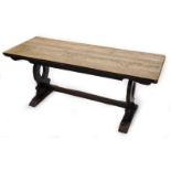 A rectangular oak refectory table, with a plank top on pierced end supports, 73cm high, the top 65cm