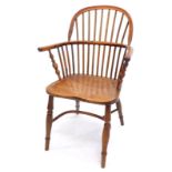 A mid 19thC yew and elm Windsor chair, with spindle turned back, solid seat and turned legs with