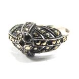 An Art Deco marcasite dress ring, with central circle with four point and three layered design, in