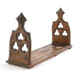 A Victorian pitch pine Gothic adjustable book holder, 43cm wide enclosed.