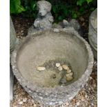 A circular composition planter, 47cm diameter, and a garden statue of a faun and puppies. (3)