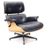 A walnut and black leather swivel armchair in the manner of Charles and Ray Eames, with a padded