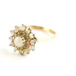 A 9ct gold opal and diamond dress ring, with central opal surrounded by a halo of diamonds and a