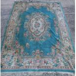 A Chinese carpet, decorated in Aubusson style, with flowers etc., on a green ground, (AF), 375cm x