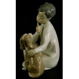 A Lladro porcelain figure group of a young child with a Spaniel puppy, impress number 45226, 19cm