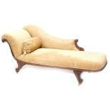 An early Victorian mahogany chaise lounge, upholstered in beige fabric, on splayed legs with brass