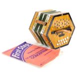 A Scholeb wooden concertina, with simulated painted wood grain, printed floral bands, etc., and a