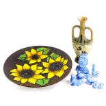 An unusual studio ware plaque, decorated with sunflowers, possibly German, various art pottery