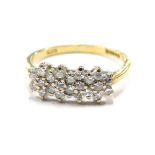 An 18ct gold diamond dress ring, set with three rows of round brilliant cut diamonds, each in claw