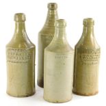 A collection of four slab seal stoneware porter bottles, to include Jabez Andrew of the Woolpack