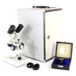 A microscope, with cream enamel paint, the lenses stamped WF10x, in fitted case.