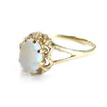 A 9ct gold dress ring, set with oval cut opal, in claw setting with flower design border, ring