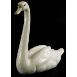 A Lladro porcelain figure of a swan, 22cm long.