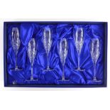 A set of six Royal Doulton cut glass champagne flutes, in original box with packaging.