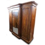 A Victorian figured mahogany triple breakfront wardrobe, with a moulded cornice above a mirrored