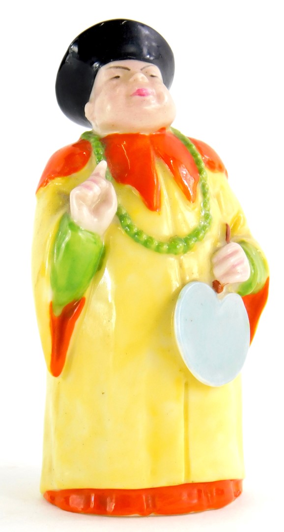 A Royal Worcester porcelain candle snuffer, modelled in the form of a Mandarin gentleman, 9cm high.