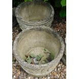 A pair of composition garden planters, each with a moulded border, 41cm diameter.