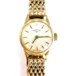 A 9ct gold Rotary ladies wristwatch, the small silvered dial on a heavy cross design 9ct gold