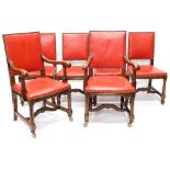 A set of six oak dining chairs, each with a red leather padded back and seat, with brass studded