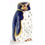 A Royal Derby porcelain paperweight, modelled in the form of a Rock Hopper penguin, gold button to