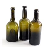 Three 19thC green glass wine bottles, approx each 26cm high.