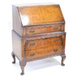 A figured walnut bureau, the quarter veneered fall enclosing a fitted interior, above three