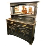 A late 19th/ early 20thC ebonised oak sideboard, the top with a carved crest, above a bevelled