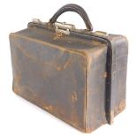 A brown leather Gladstone style travel bag, with fitted pigskin interior for gentleman's toiletries,