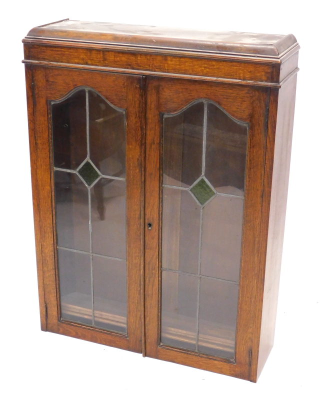 An early 20thC oak bookcase, with leaded glazed and stained glass doors, 95cm x 72cm.