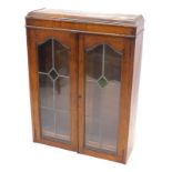 An early 20thC oak bookcase, with leaded glazed and stained glass doors, 95cm x 72cm.