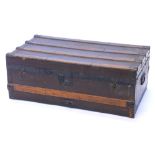 A canvas and wooden bound trunk, with metal brackets and side handles, 79cm wide.