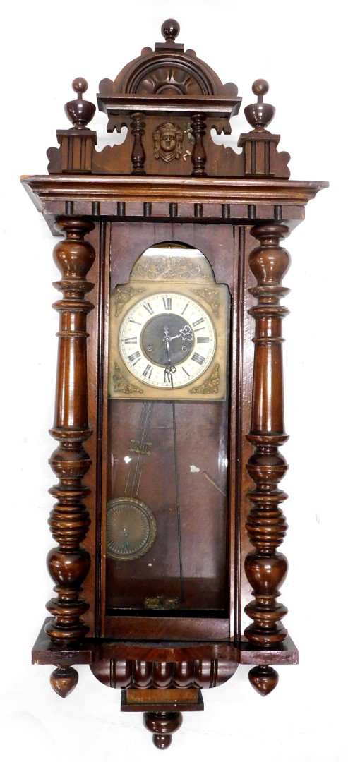 A Vienna wall clock, in a walnut case with part enamel and brass dial, flanked by a pair of
