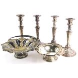 A set of four silver plated candlesticks, each with a reeded column and a domed foot, 28cm high, and