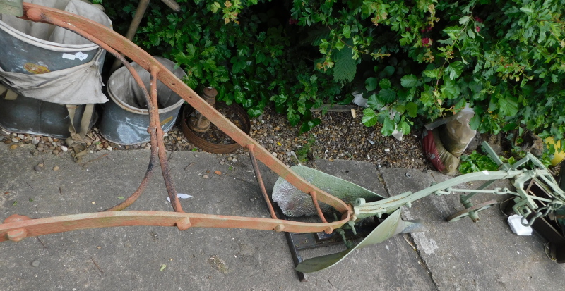 A green painted agricultural iron plough, 297cm long approx.