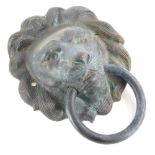 A bronze door knocker, cast in the form of a lion mask with a ring, 15cm wide.