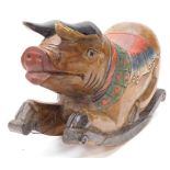 An Eastern carved hardwood rocking pig, with polychrome painted saddle etc., on scrolled carved