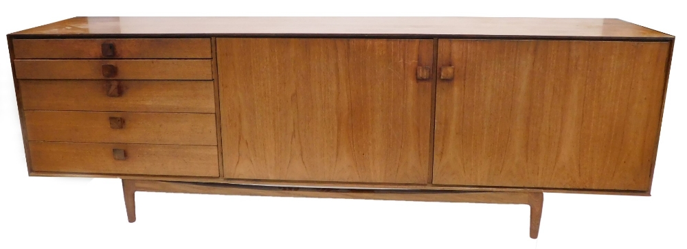 A 1960's teak sideboard, possibly Kefod Larsson for G-plan, with five graduated drawers, and two