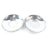 A pair of Edwardian silver stands or saucers, of plain form, stamped to underside Ollivant and